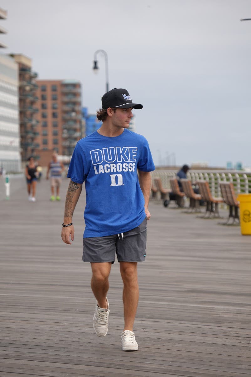 Duke Lacrosse Tee on model walking down the boardwalk