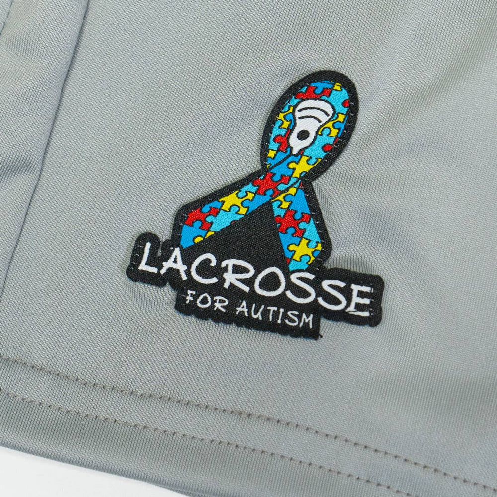unltd X StringKing Autism Awareness Monarch Lacrosse Short zoomed in on embroidered Autism logo