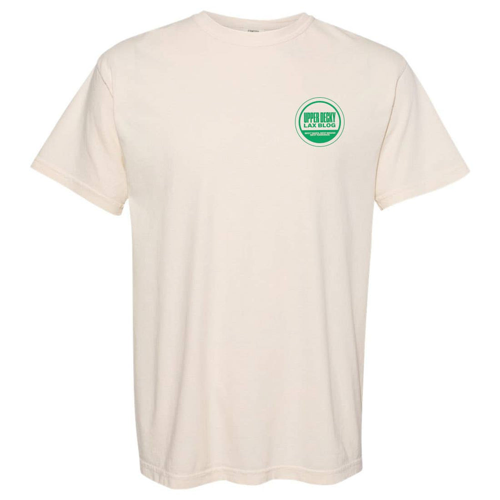 Front of  ivory shirt with green circle in top left chest. inside green shirt says "Upper Decky Lax Blog. Best takes, Best brand, best rankings