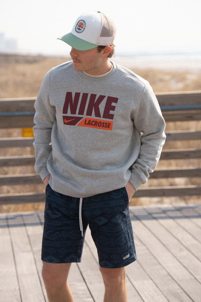 Nike Lacrosse crew neck on model full body at the beach with ganado blue stone tactical lacrosse shorts