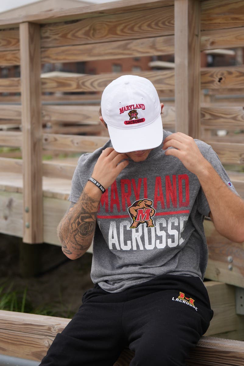 Maryland Lacrosse Tee on model sitting on boardwalk railing