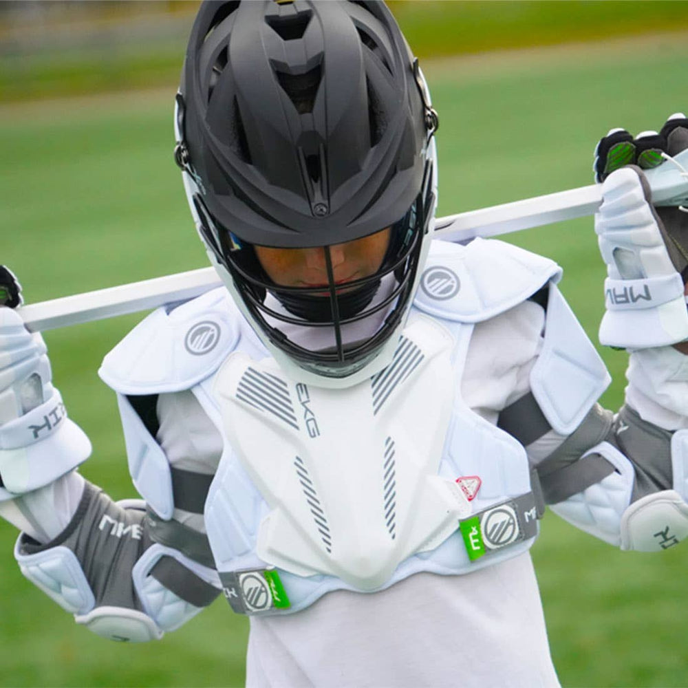 Person in lacrosse gear holding a lacrosse stick on a field.