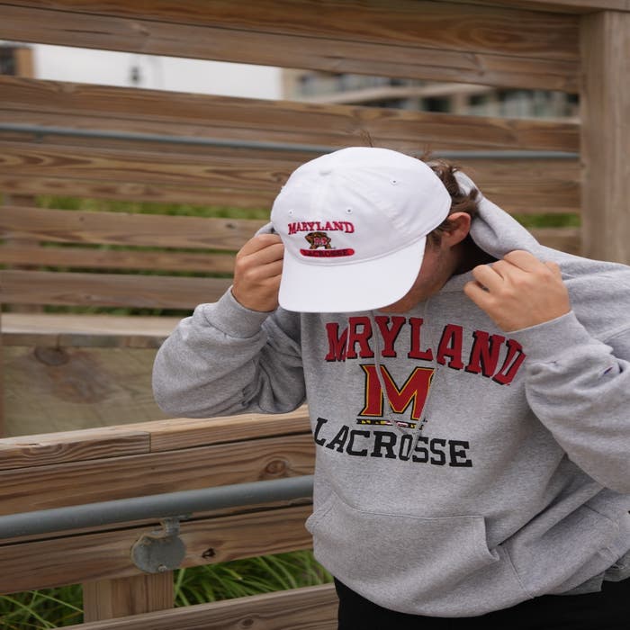 Maryland Lacrosse Hoodie on model putting hood up