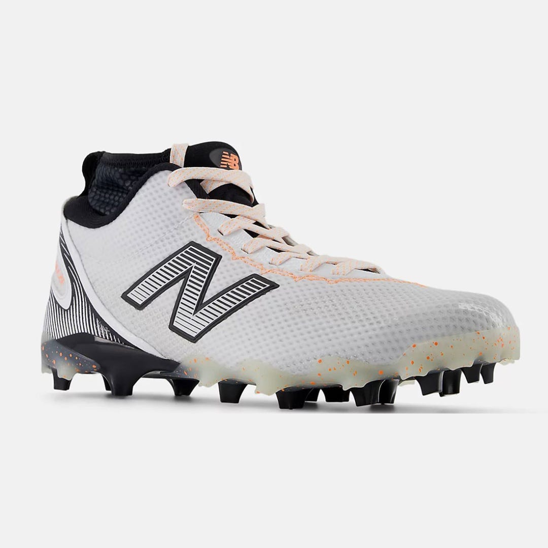 New Balance Burn X4 white lacrosse cleats on athlete