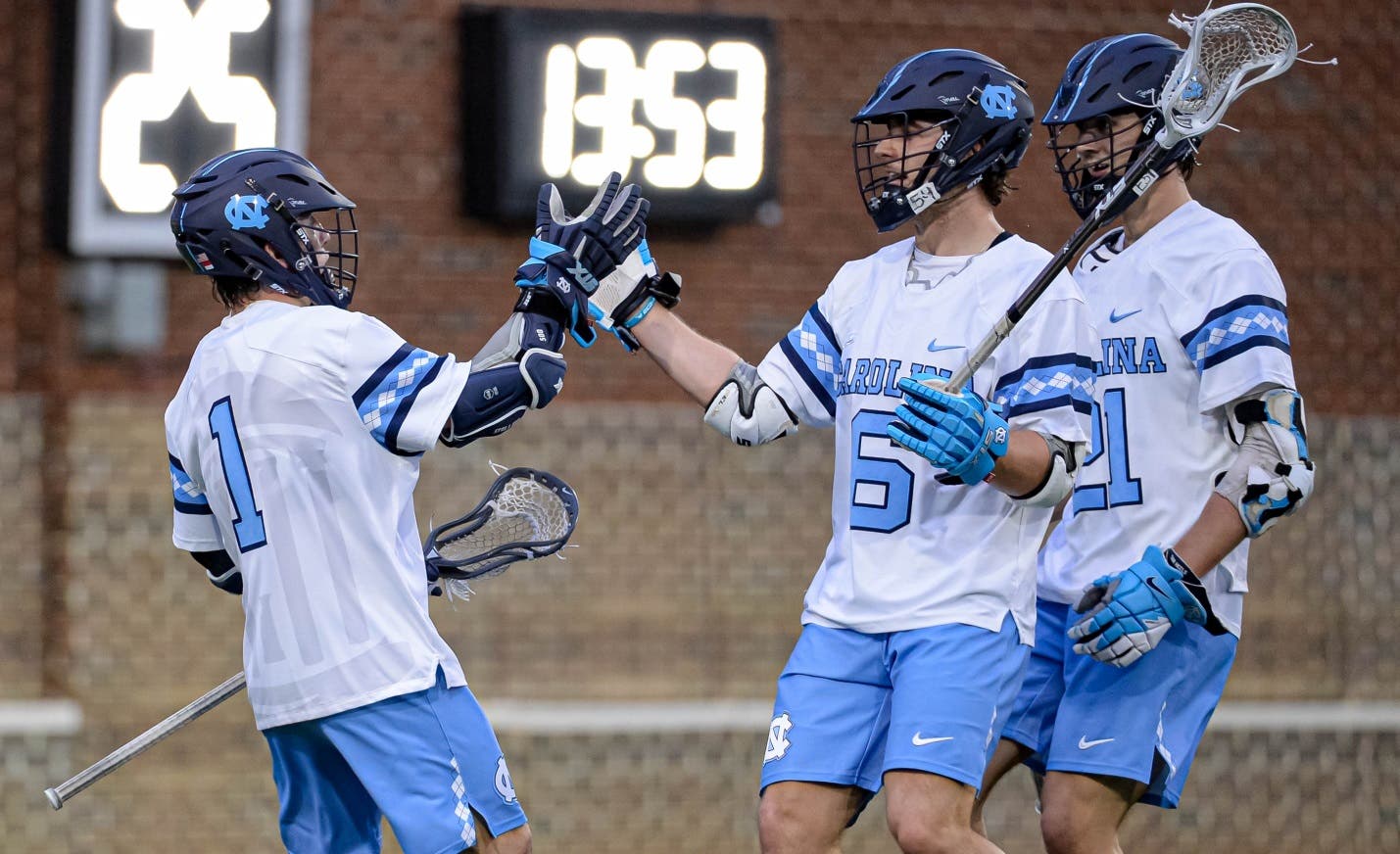 UNC Lacrosse team high fiving